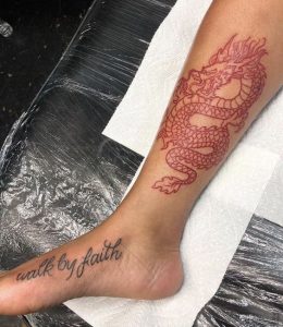 Red dragon tattoo in ankle