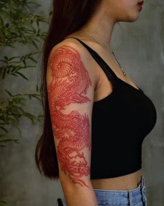 Red dragon tattoo on arm