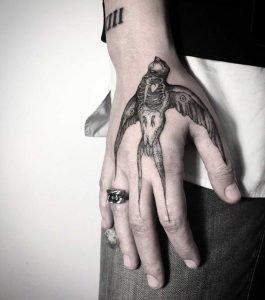black bird hand tattoo