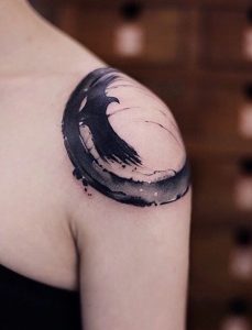black bird tattoo on shoulder